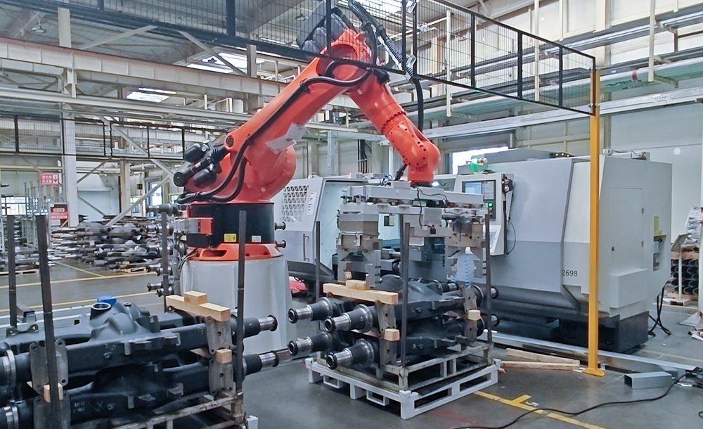 robot performing vision-guided positioning and loading/unloading on a large housing line